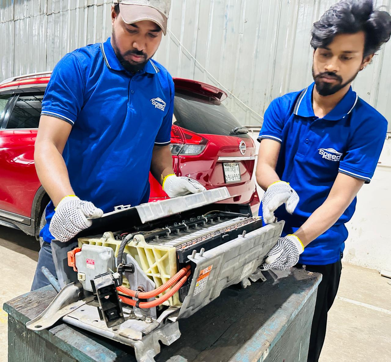 Speed Auto Care technicians inspecting a hybrid battery pack
